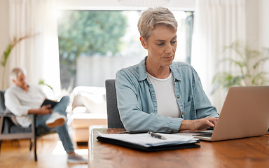 Image showing Woman on laptop doing financial budget, taxes or planning monthly finance bank payment at home living room desk. Lady working remote on debt solution, typing on computer and husband reading a book