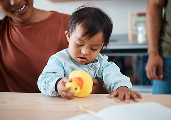 Image showing Sleeping, disability and baby with down syndrome after playing with toy asleep on his mothers lap in family home. Mama, exhausted and tired child with special needs in development with lovely parents