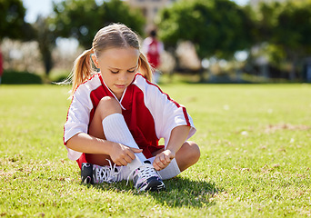 Image showing Sports, girl and soccer player with child on grass before outdoor game and exercise. Kids, fitness and shoes during football training, getting ready for exercise and soccer practice on a field