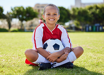 Image showing Sports, happy and girl. relax on soccer field after game, competition or fitness cardio exercise. Sitting, kid child or young athlete with smile after youth football, practice or training workout