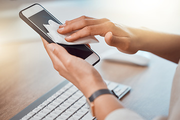 Image showing Clean, office and woman hands cleaning phone screen with wet wipes for hygiene, cleaniness and disinfection of bacteria, virus or coronavirus. Closeup female hands wiping smartphone at office desk