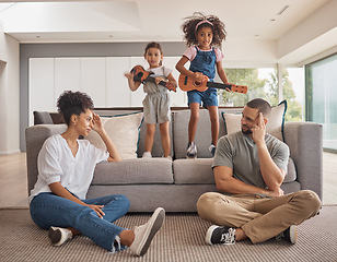 Image showing Stress, family and energy with kids playing music on a guitar in the living room at home while giving mom and dad a headache. Mental health, children and tired with a girl and sister causing chaos