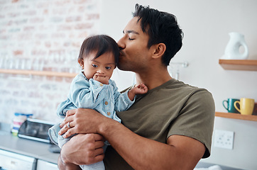 Image showing Down syndrome baby bonding with father in their home, kiss and affection by caring parent for special needs infant. Love, family and children with asian parent embracing newborn with disability