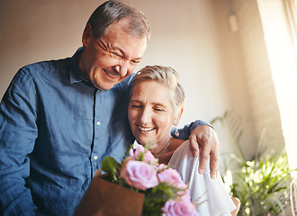 Image showing Couple, romance and flowers with a senior man and woman in celebration of valentines day or their anniversary. Retirement, love and affection with an elderly male and female pensioner in their home