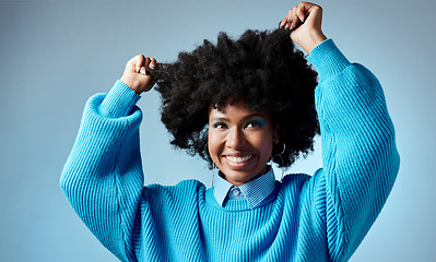 Image showing Happy, black woman and healthy natural hair with afro against blue studio mockup background. Young beautiful female model looking trendy, beauty and empowerment with smooth glowing skin and fashion
