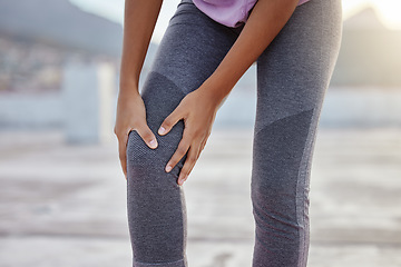 Image showing Knee injury, fitness and woman with pain while training for health in the city of Turkey. Legs and hands of an athlete runner with medical emergency after running, cardio or workout accident