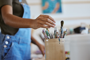 Image showing Woman, artist and hand of painter reaching for paintbrush in studio, creative workshop or art class painting. Closeup of female doing artwork and craft as hobby with a brush set or collection inside