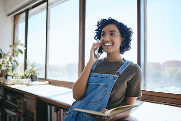 Image showing Phone call, communication and creative business woman talking and planning advertising project on a smartphone. Black woman networking on cellphone and reading notes in notebook in an office at work