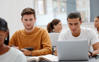 Image showing Education, laptop and student cheating in classroom working on test, exam or research. University, learning and college man writing notes, assignment or busy peeping on friends computer in lecture.