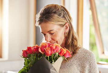 Image showing Mature woman, scent and smelling roses in house or home for valentines day, birthday and celebration event. Flowers, plants and floral bouquet for person as thank you, sorry or congratulation gesture