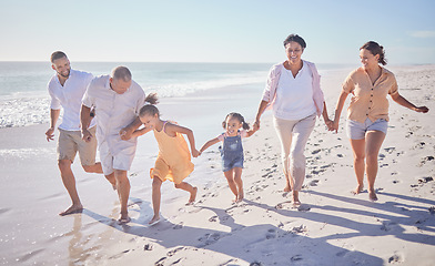 Image showing Beach walk, family summer and children holding hands with grandparents while walking by the sea on holiday. Parents, girl kids and senior people walking by the ocean on travel vacation in Brazil