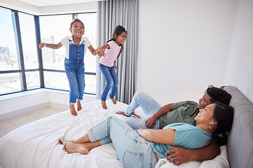 Image showing Relax, happy family and kids jump on bed mattress in Philippines home with parents watching. Young, excited and happy children enjoy leisure fun together with mom and dad in cozy bedroom.