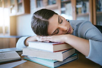 Image showing Sleeping, tired and fatigue student with books studying for university exam, learning and knowledge in a library or education workspace. English, literature college woman burnout with school research