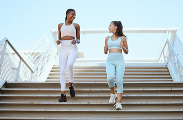 Image showing Fitness women, running steps and exercise for healthy lifestyle, wellness and marathon training in urban city outdoors. Happy athletes, runners and friends cardiovascular workout down stairs together