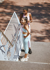 Image showing Exercise, running and friends relax and take a break from morning workout in a city, talking and bonding on steps. Health, fitness and training by athletic females enjoying rest and conversation
