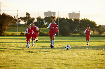 Image showing Sports, fitness and soccer training by girl team playing on grass field, teamwork during football game. Health, exercise and children learning to play in competitive match with energy and soccer ball