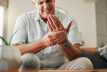 Image showing Senior man, hands and wrist joint pain in living room home from carpal tunnel, osteoporosis and arthritis. Elderly, sick and stress male, orthopedic muscle injury and fibromyalgia health risk problem