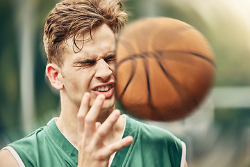 Image showing Sports, basketball and accident with face in game match on athlete court for tournament training. Injured man in professional outdoor fitness centre in pain from impact of ball hit action.