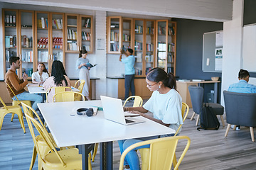 Image showing Students, laptop and modern library for education, learning and study on school campus. Men, women or people with technology for homework, university research and scholarship review for future growth