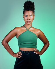 Image showing Green fashion, beauty and makeup with a black woman hands on hips in studio on a wall background. Portrait, cosmetics and style with a young female posing for a contemporary style photo shoot