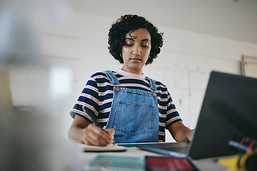 Image showing Black woman writing notes, studying on laptop and working on living room desk from home. African American girl, digital learning from inside her house and working on elearning education course online