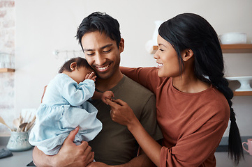 Image showing Love, baby and happy parents bonding and caring for their infant child in their comfy home. Happiness, smile and care with an interracial family, man and woman standing together in New york house