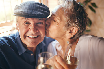 Image showing Love, toast and old couple kiss with champagne in celebration of a happy marriage anniversary together at home. Smile, romance and senior woman enjoying a relaxing wine date and drink elderly partner