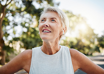 Image showing Fitness, relax and running with old woman with earphones listening to music, podcast or audio for motivation. Health, workout and sports with senior lady in nature training for happy and freedom