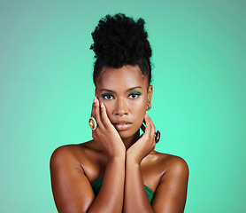 Image showing Fashion, beauty and makeup with a black woman or model in studio on a green background for empowerment and equality. Cosmetics, hands and trendy with a beautiful female touching her beautiful face