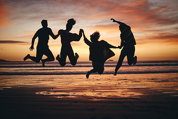 Image showing Freedom, jump and silhouette of friends at the beach and travel on brazil vacation for success, happy or motivation. Teamwork, collaboration and shadow of people at sunset for summer, youth and fun