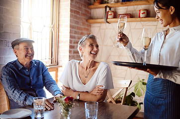 Image showing Senior couple, waiter and champagne in restaurant for wedding anniversary, celebration or birthday. Happy elderly man and woman smile with waitress and serve alcohol to celebrate retirement event