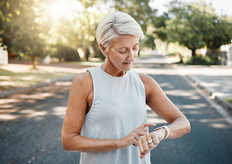 Image showing Fitness runner or senior woman with smartwatch check exercise results, process or goal for healthy, wellness lifestyle. Elderly sports person on digital technology typing workout steps or data on arm