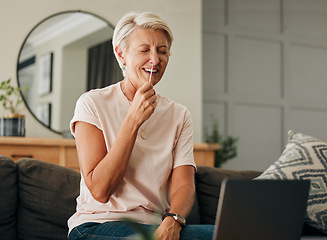 Image showing Covid, laptop and pcr with senior woman laughing during online consultation or tutorial video for self test antigen rapid kit on home sofa. Old lady doing coronavirus nasal swab in Australia house