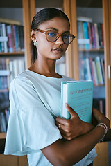 Image showing Woman student with library print books from shelf for college or university education and learning knowledge. Young female or person with hardback English book in hands for studying or reading