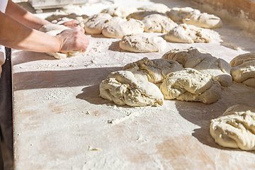 Image showing Bakers standing at a work table