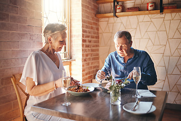 Image showing Food, date and senior couple eating at fine dining restaurant and having lunch together at a table. Elderly man and woman with dinner in marriage at cafe or coffee shop during retirement for love