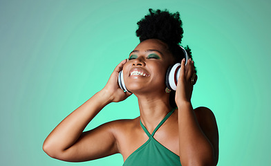 Image showing Studio, happy and black woman in headphones with music playing from a Jamaican dance hall and reggae radio audio playlist. Freedom and young African girl enjoying listening fun, streaming and sounds