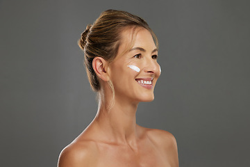 Image showing Mature woman, face cream or sunscreen in skincare routine for healthy glow, sun damage protection or healthcare wellness. Smile, happy or product on beauty model on grey studio background with mockup