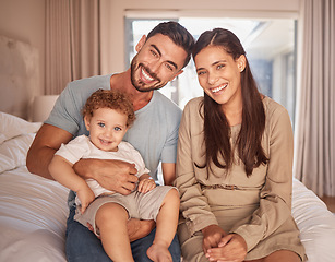 Image showing Mom, dad and baby on bed with smile in room together at home in Miami. Parents, bedroom and happy child bonding in bedroom show love in portrait of family in house, apartment or hotel to relax