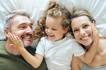 Image showing Family, happy and smile of people from above in bed at home relax in a bedroom. Mother, girl and man with happiness together in a house with love, care and calm smiling with a positive mindset