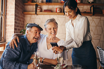 Image showing Couple, restaurant and date with a senior man and woman paying their bill with a waitress on her phone. Payment, service and romance with an elderly male and female pensioner on their anniversary