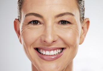 Image showing Face makeup, beauty and mature woman with smile for skincare cosmetics against a grey mockup studio background. Portrait headshot of an elderly model happy about facial cosmetic care and wellness