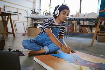 Image showing Music, painting and art with woman on floor of workshop studio working on creative, idea or vision on canvas. Relax, designer and goals with girl artist and headphones for peace, wellness or freedom
