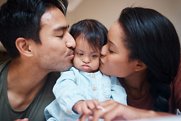 Image showing Love, disability and down syndrome parents kiss special needs kid with appreciation. Mom, dad and disabled baby in Puerto Rico home with happy and caring family bonding together.