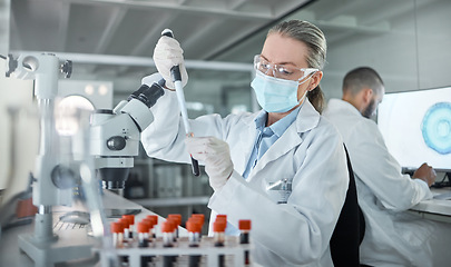 Image showing Lab research, covid science and scientist working on medical blood development for future at work. Chemistry doctor with face mask for security from virus and chemical during biotechnology test