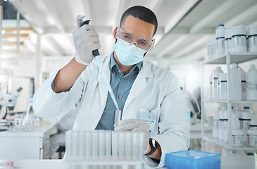 Image showing Covid, science and research with man in laboratory with a face mask working on medical, pharmacy and vaccine investigation. Innovation, healthcare and medicine with expert scientist and chemistry