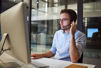 Image showing Telemarketing, man and employee in call center with headphones at desk. Worker or consultant at table on computer talking to client, checking information or consulting customer with technical support