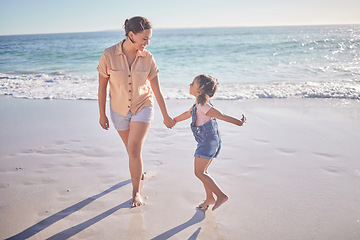 Image showing Beach, smile and happy mother with excited girl walking on the sand during summer travel vacation. Wellness, care and freedom with woman and child play together on costa rica family holiday outdoor