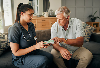 Image showing Nurse, senior man and home care or consultation for healthcare and medicine prescription with a caregiver reading on medication box. Female medical worker talking to a old male sitting on a sofa