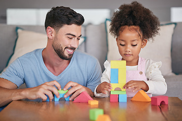 Image showing Father, adopted child and building blocks on table playing with little girl in living room at home. Happy dad smiling in playful build activity with colorful shapes, toys and daughter in development